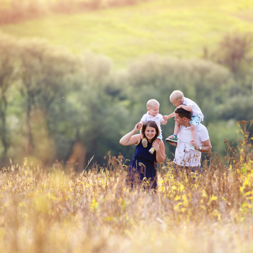 Mom and Dad with two young boys enjoying free time hike